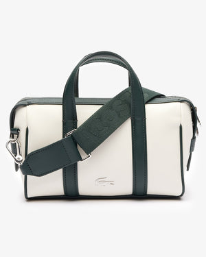 White handbag with green strap and accents on a white background